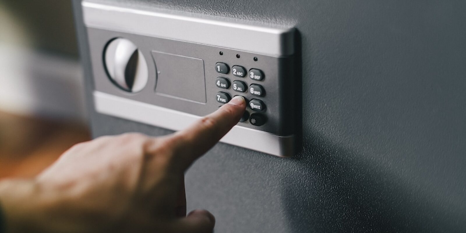 man opens safe, combination lock